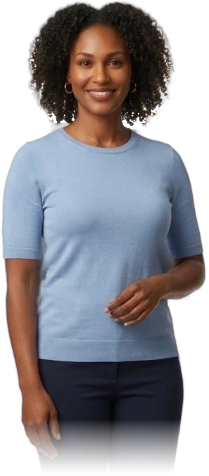 A smiling woman in a soft blue top
